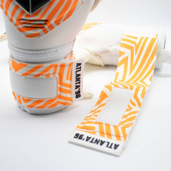 Guantes de Arquero Atlanta'96 Orange Contacgrip goalkeeper gloves with orange and white wrist straps on white background